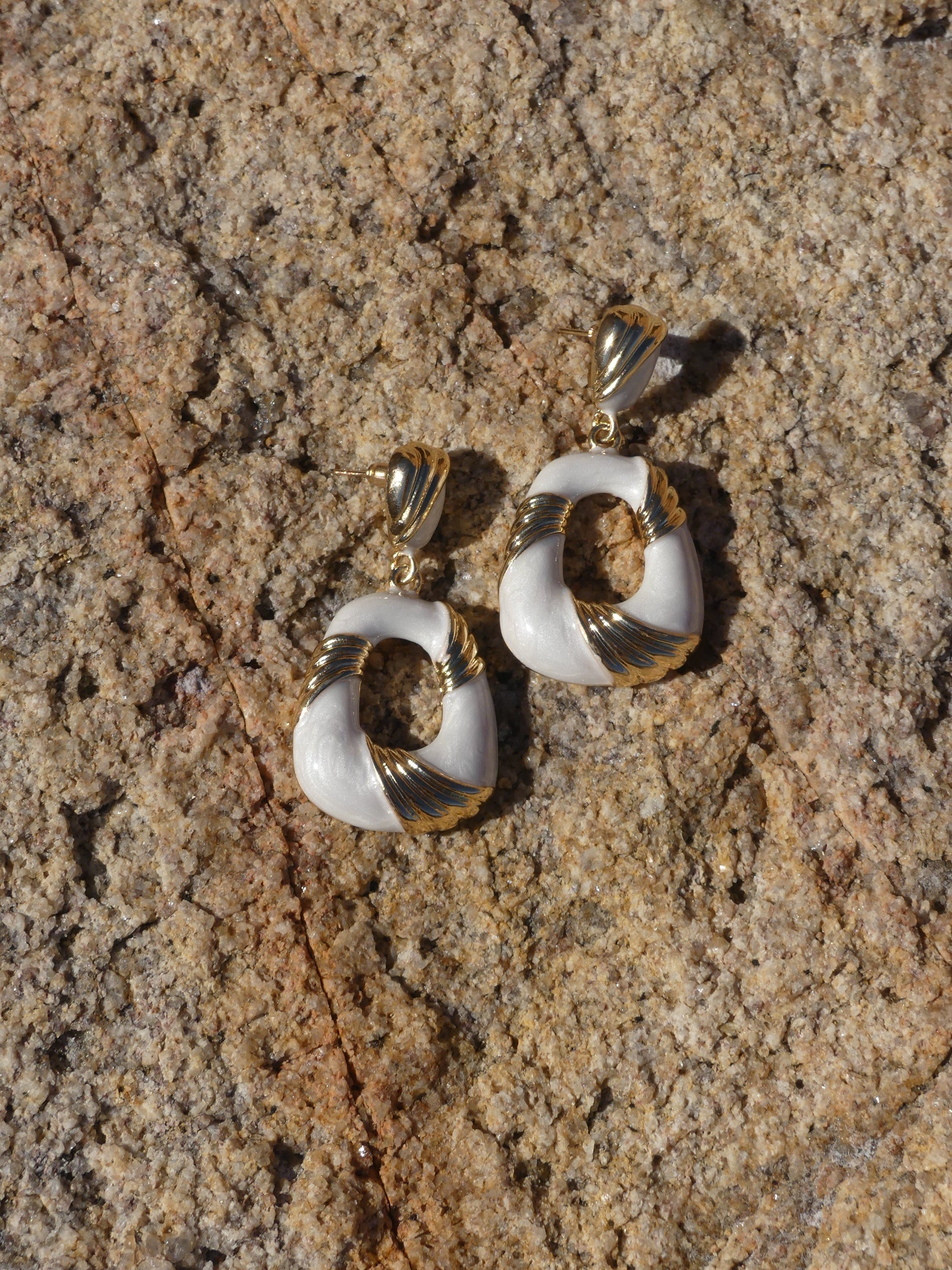 Elegant stud earrings No. 9 with gold-tone accents and ivory enamel, featuring a sculptural circular design.